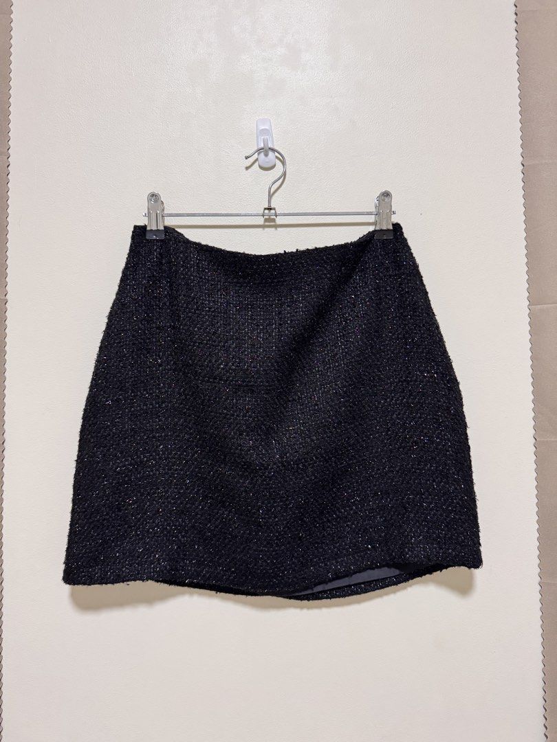 Black Tweed Skirt (Category: Skirts) located in Manila. Submitted by seayouncey (Listing ID 1470053696, Image 1). Description: Size: waist line 29 inchs, length 15 inchs - Brand: Primark - Size: UK 10 / EUR 38 / USA 6 - Color/Fabric: Black textured tweed with subtle sparkle - Features: Structured shape, smooth inner lining, hidden back zipper closure - Condition: Excellent, clean fabric with no pulls or visible wear.