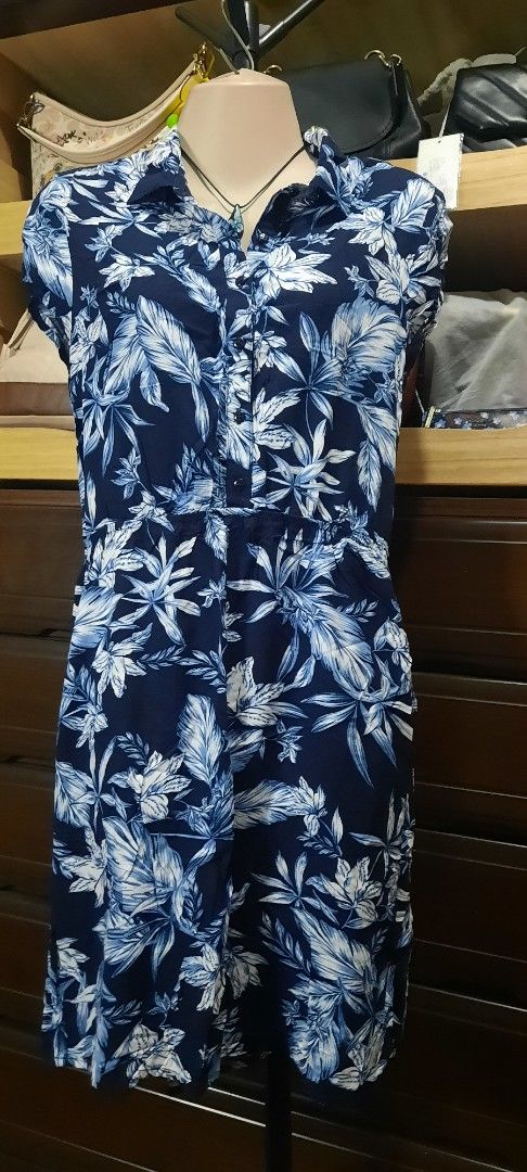 Blue and White Floral Jumpsuit (Category: Jumpsuits) located in Manila. Submitted by gracjam_27 (Listing ID 1470034259, Image 1). Description: - Color/Design: Navy blue with white tropical flower print - Features: Short sleeves, button-down front, collar, and easy slip-on style - Waist: Cinched elastic waist for a flattering fit - Fabric: Lightweight and breathable, ideal for warm weather or beach trips - Condition: Clean, well-maintained, and re