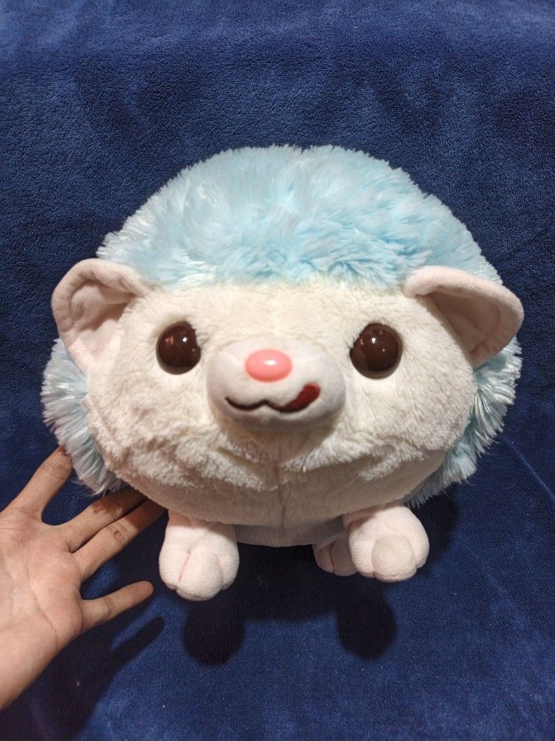 Blue Hedgehog Plush Stuffed Toy (Category: Plushies & Soft Toys) located in Manila. Submitted by kirstentoyshub (Listing ID 1470016274, Image 1). Description: - Adorable blue and white hedgehog plush toy - Super soft, squishy, and huggable texture - Features large brown eyes, pink nose, and cute paw details - Unique star patch design on the back - Excellent and clean condition (no tears or stains) - Perfect for gifts, kids, or plushie collectors.