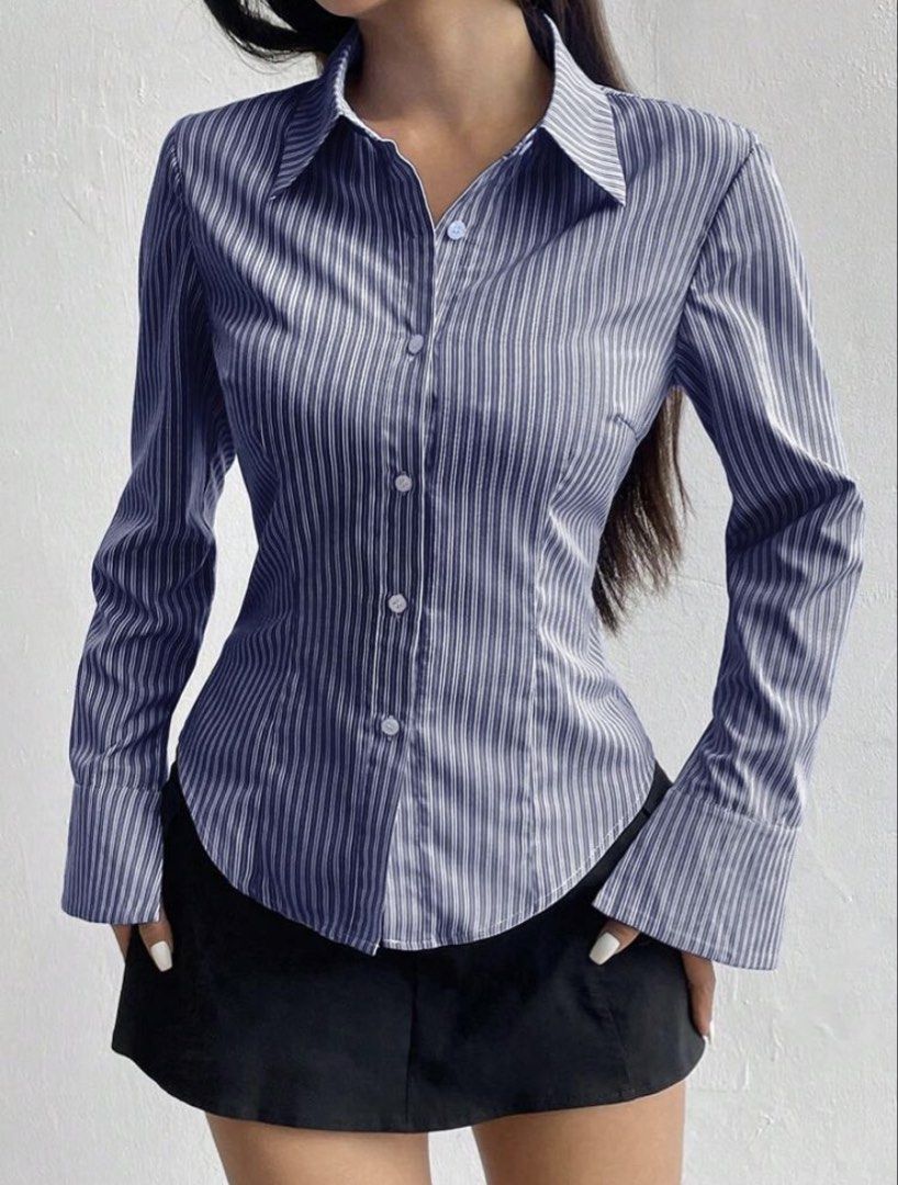 Blue Striped Button-Down Shirt with Wide Cuffs (Category: Longsleeves) located in Quezon City. Submitted by declutteraia (Listing ID 1470053817, Image 1). Description: - Design: Blue and white vertical striped long sleeve button-down - Details: Lapel collar neckline, front button closure, and curved hemline - Fit: Fitted silhouette with trendy extra wide flared cuffs - Versatility: Ideal for corporate casual wear or stylish streetwear - Styling: 