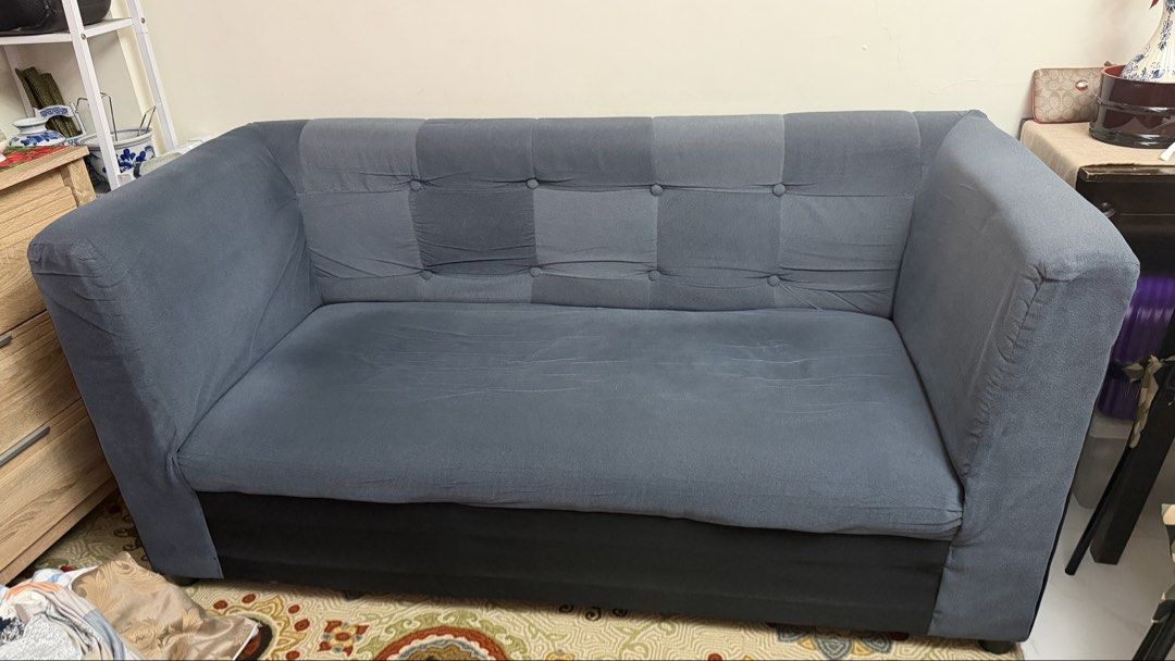Blue Upholstered Two Seater Sofa (Category: Sofas) located in Quezon City. Submitted by sahly.closets (Listing ID 1470046033, Image 1). Description: - 3 seater sofa upholstered in solid blue fabric - Stylish button-tufted backrest with clean grid design - Wide padded armrests for extra comfort - Sturdy solid frame construction - Dark fabric base - Ideal for living rooms or lounge spaces - Pick up only.