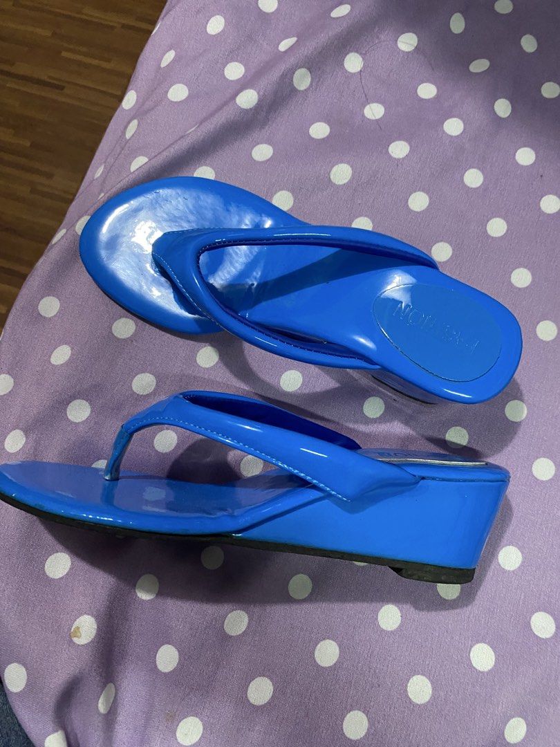 Bright Blue Wedge Thong Sandals (Category: Wedges) located in Guinobatan. Submitted by whtvrim (Listing ID 1469986809, Image 2). Description: - Color: Bright blue with a glossy finish - Style: Thong strap wedge sandals - Condition: Worn once, soles show barely any wear - Comfort: Adds a bit of height while keeping feet comfortable - Perfect for: Adding a vibrant pop of color to sunny day outfits.
