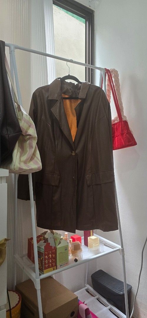 Brown Leather Coat with Yellow Lining (Category: Coats, Jackets and Outerwear) located in Manila. Submitted by cee_gotaway6991 (Listing ID 1469959158, Image 1). Description: - Features a striking bright yellow inner lining for a pop of color - Classic front button closure and practical front flap pockets - Structured collar and long sleeves for a polished look - Ideal outerwear piece to keep you warm during cooler weather.