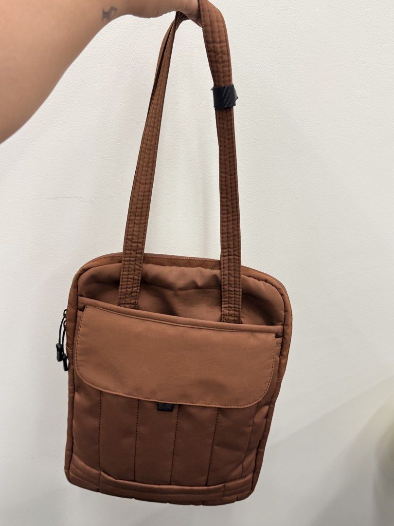 Brown Padded Multipurpose Laptop Bag with Front Pocket (Category: Tote Bags) located in Bacolod City. Submitted by _cuteclutters (Listing ID 1470032699, Image 1). Description: - Color & Design: coffee colored quilted tote with stylish vertical stitching - Material: Lightweight fabric, ideal for everyday use and running errands - Storage: Secure zippered main compartment with smooth dual cord pullers - Quick Access: Convenient front flap pocket fo