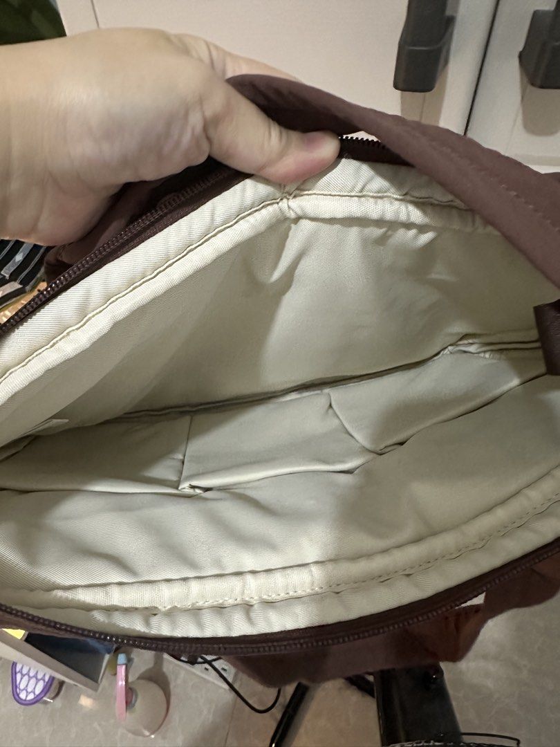Brown Puffer Laptop Bag Tote (Category: Tote Bags) located in Cabanatuan. Submitted by zarrah.mendoza0926 (Listing ID 1470138036, Image 3). Description: - Brown quilted nylon laptop bag - Padded material for maximum electronics safety - Main zipper compartment with light fabric lining and inner slip pockets - Front pocket with secure magnetic snap closure - Sturdy shoulder straps featuring a convenient snap connector Shipping fee care of buyer vi