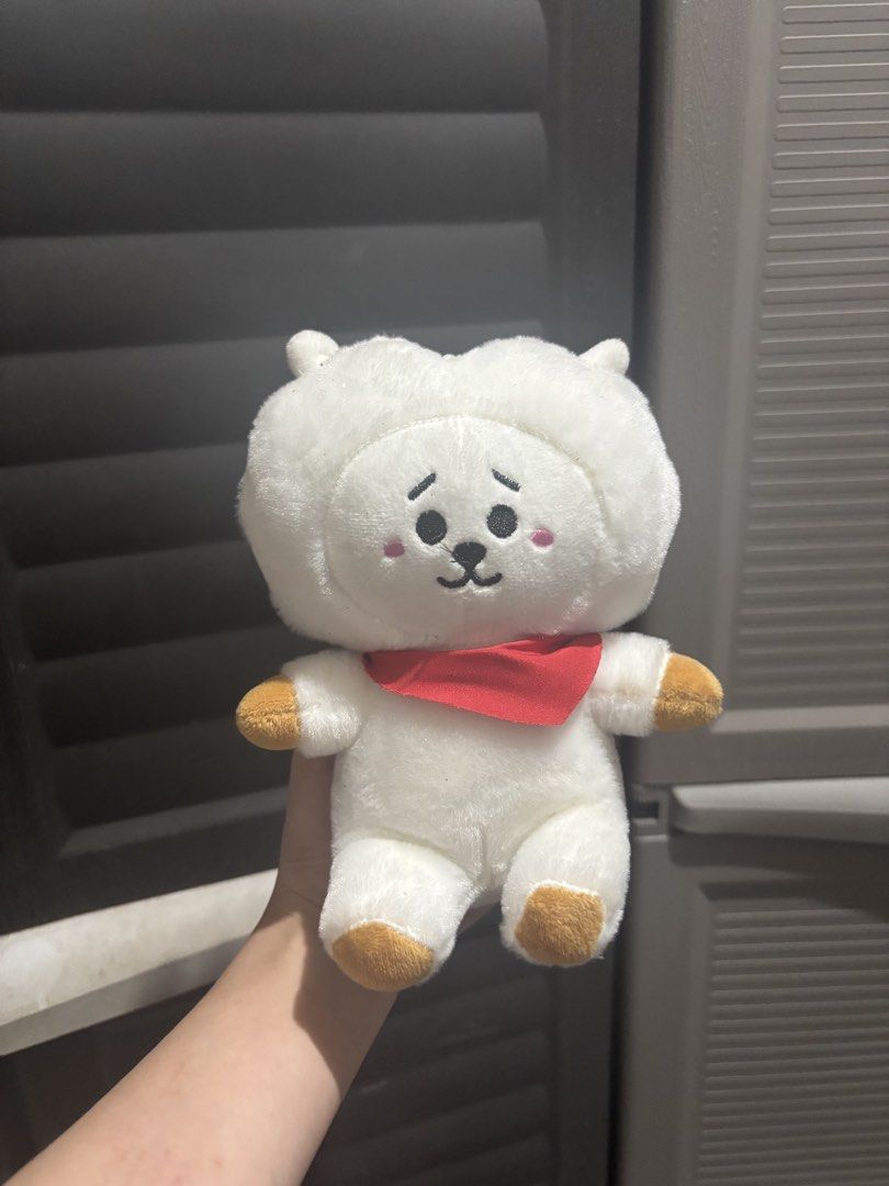 BT21 RJ plush toy (Category: Plushies & Soft Toys) located in Caloocan City. Submitted by aclyy (Listing ID 1470039023, Image 1). Description: - Super soft, fluffy white fabric with adorable embroidered face and pink cheeks - Features cute brown paws and a detachable red scarf - Excellent, clean condition with no stains or damage - Perfect size for hugging, cuddling, or shelf display.