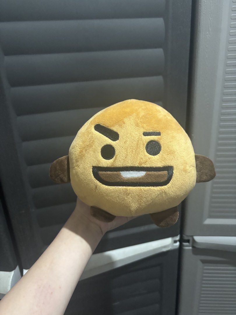 BT21 SHOOKY Plush Toy (Category: Plushies & Soft Toys) located in Caloocan City. Submitted by aclyy (Listing ID 1470038801, Image 1). Description: - Color: Golden brown with little brown arms and feet - Design: Smiling face with a playful raised eyebrow - Material: Soft, velvety fabric - Condition: Excellent, clean with no stains or flaws - Environment: Stored in a smoke-free home.