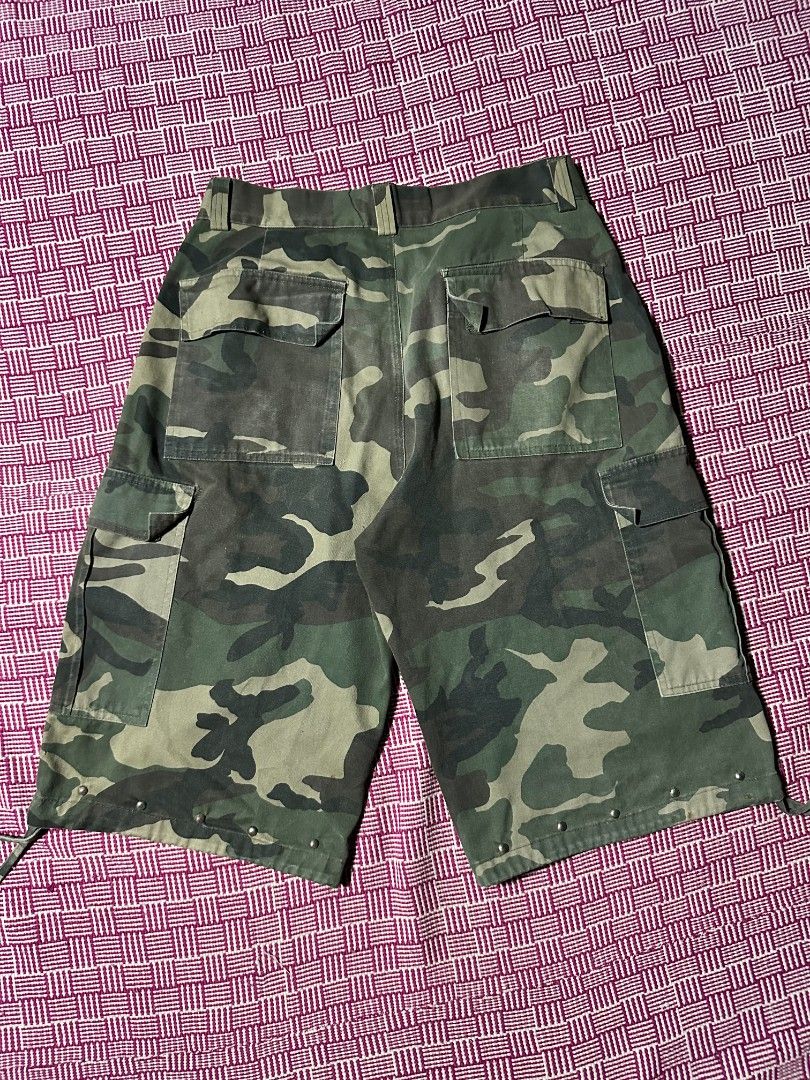 BTL Camouflage Cargo Shorts Size 34 (Category: Shorts) located in Manila. Submitted by wardrobeph.com (Listing ID 1470123057, Image 2). Description: - Brand/Model: BTL camo cargo shorts - Size: 34 - Pattern: Classic green camouflage - Pockets: Multiple functional pockets on sides and back - Details: Metal studs along the lower hem - Fit: Adjustable drawstrings at leg openings - Material: Durable cotton - Style: Great streetwear look.