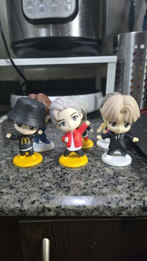 BTS McDonald's Mini Figures Figurines Toy Set (Category: Designer & Blind Box Toys) located in Muntinlupa City. Submitted by kc_10 (Listing ID 1470105398, Image 1). Description: - Official BTS x McDonald's inspired chibi figure set - Features members in iconic looks including the black bucket hat, red jacket, and black suit - Each figure comes with its own yellow or white display base - Must-have collectible for K-pop fans and toy collectors - Sh