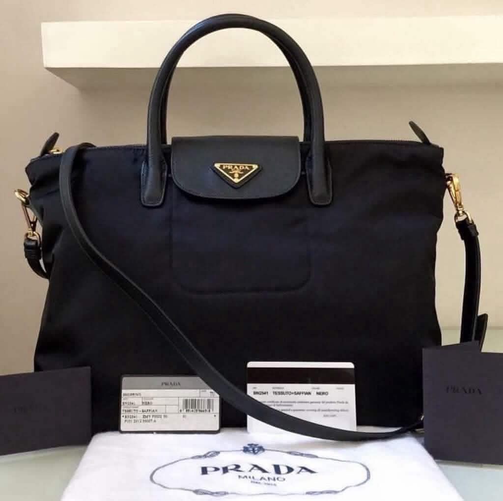BUNDLE Prada Black Nylon Handbags (Category: Luxury Bags & Wallets) located in Makati City. Submitted by mariaasevilla0622eb (Listing ID 1469967853, Image 2). Description: - Authentic black Prada nylon handbags (Choice of 2 distinct styles) - Left Bag: Features elegant gathered ruching, luxury gold hardware, dual buckled straps, and a hanging clochette - Right Bag: Features classic dual top handles, a functional front flap pocket, and the iconic 
