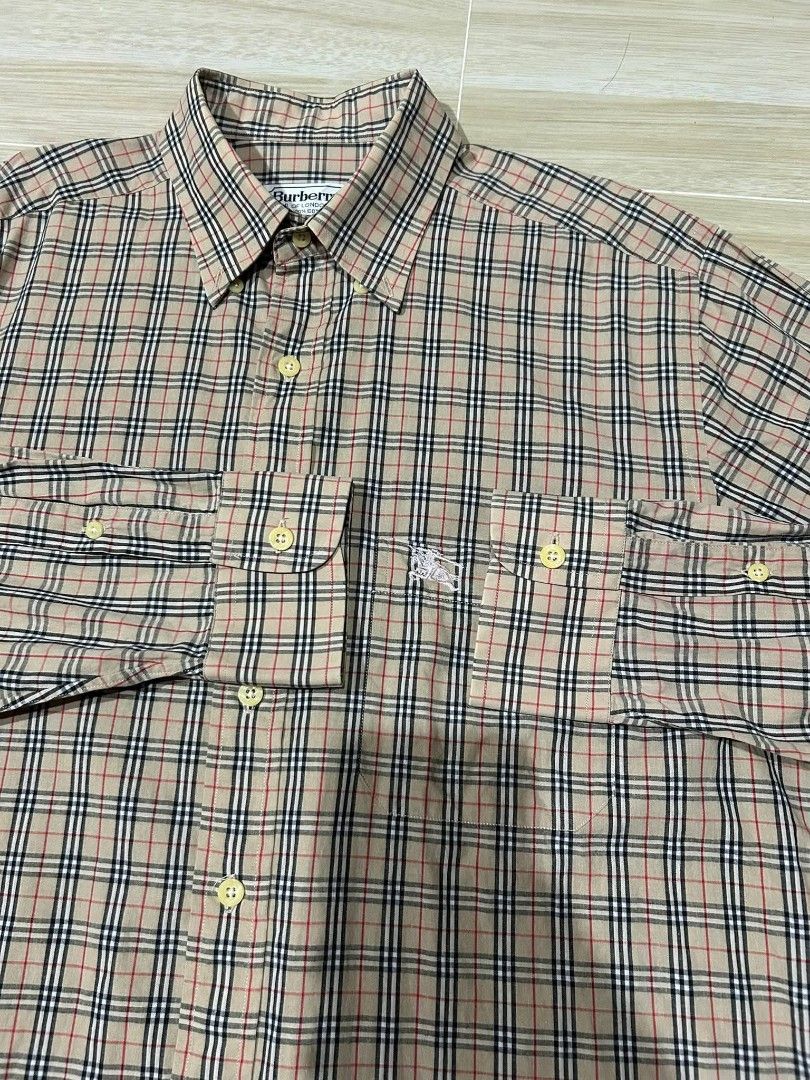 Burberry plaid long sleeve polo (Category: Tshirts & Polo Shirts ) located in Manila. Submitted by thegoodstuffs__ (Listing ID 1470139778, Image 2). Description: - Brand: Burberry - Item: Plaid long sleeve polo - Size: L (39) - Material: 100% cotton, breathable and comfortable - Design: Classic beige check pattern with button-down collar and chest pocket featuring embroidered logo - Condition: Excellent pre-owned condition - Ideal for: Smart casu