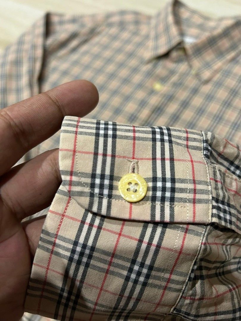 Burberry plaid long sleeve polo (Category: Tshirts & Polo Shirts ) located in Manila. Submitted by thegoodstuffs__ (Listing ID 1470139778, Image 3). Description: - Brand: Burberry - Item: Plaid long sleeve polo - Size: L (39) - Material: 100% cotton, breathable and comfortable - Design: Classic beige check pattern with button-down collar and chest pocket featuring embroidered logo - Condition: Excellent pre-owned condition - Ideal for: Smart casu