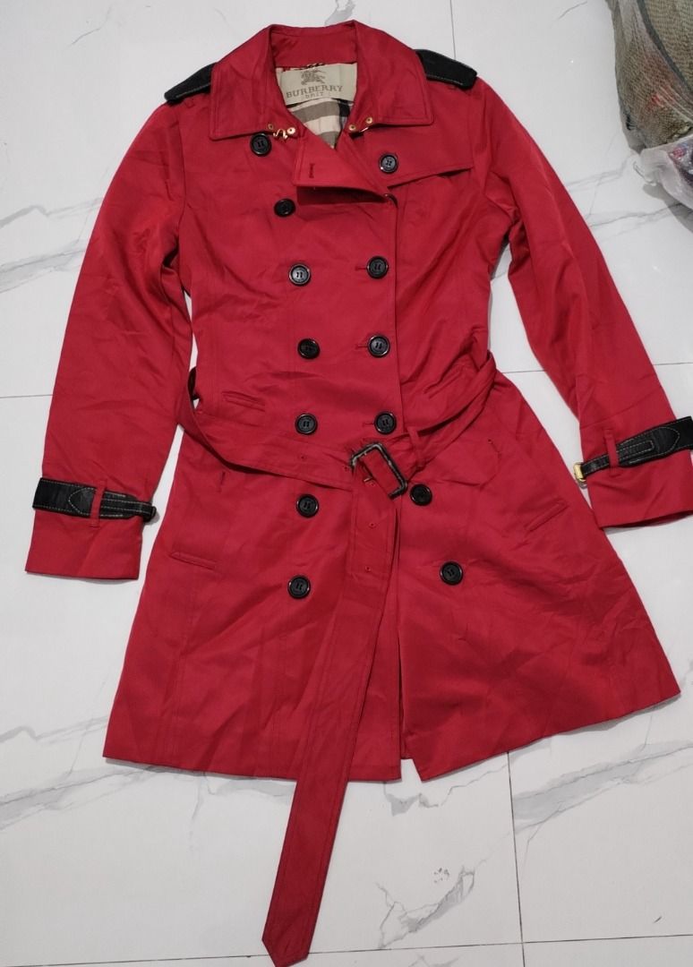 Burberry trench coat (Category: Luxury Apparel) located in Caloocan City. Submitted by raymonms (Listing ID 1470067906, Image 1). Description: Red Burberry The Sandringham Heritage Trench Coat featuring a double-breasted button front, shoulder epaulets, and a belted waist..