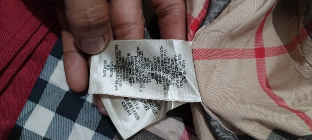 Burberry trench coat (Category: Luxury Apparel) located in Caloocan City. Submitted by raymonms (Listing ID 1470067906, Image 3). Description: Red Burberry The Sandringham Heritage Trench Coat featuring a double-breasted button front, shoulder epaulets, and a belted waist..