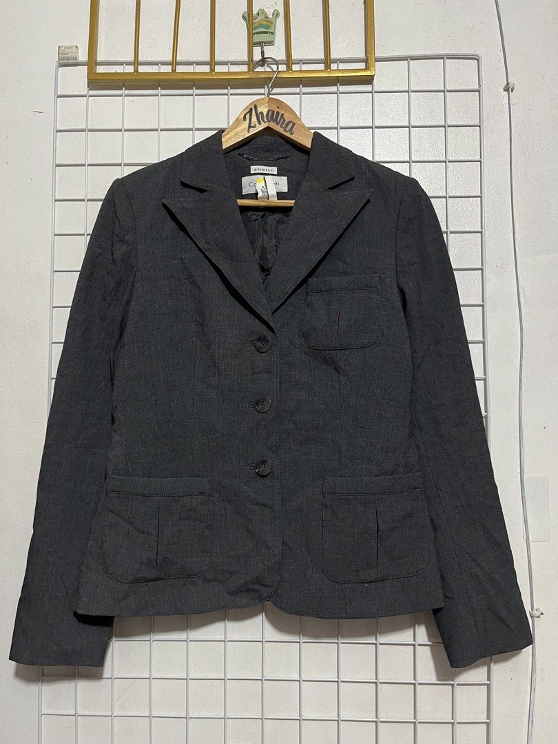 Calvin Klein Dark Grey Stretch Blazer Size 4 (Category: Coats, Jackets and Outerwear) located in Pagsanjan. Submitted by zhairaaaaa (Listing ID 1470100600, Image 2). Description: - Brand: Calvin Klein - Size: 4 - Color: Dark Grey - Material: Polyester, rayon, and spandex blend with polyester lining - Features: Button-front closure, front pockets, one chest pocket - Fit: Classic tailored fit - Condition: Verygood / Ready to wear - Perfect for offi