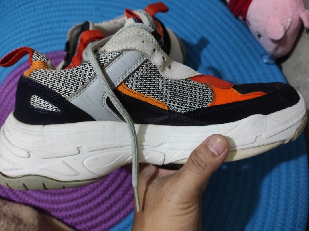 Calvin Klein Jeans Chunky Sneakers Multi-color (Category: Sneakers) located in Quezon City. Submitted by adibagtas (Listing ID 1469955338, Image 3). Description: - Brand: Calvin Klein Jeans - Style: Chunky sneakers with a bold black, orange, grey, and white colorway - Soles: Chunky white rubber sole with good grip (minor wear) - Upper: Textured mesh panels for breathability - Condition: Solid daily kicks, includes laces - Perfect for daily wear a
