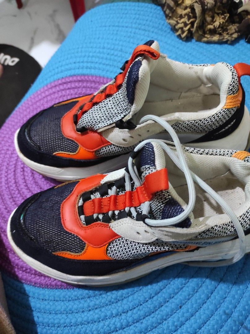 Calvin Klein Jeans Chunky Sneakers Multi-color (Category: Sneakers) located in Quezon City. Submitted by adibagtas (Listing ID 1469955338, Image 1). Description: - Brand: Calvin Klein Jeans - Style: Chunky sneakers with a bold black, orange, grey, and white colorway - Soles: Chunky white rubber sole with good grip (minor wear) - Upper: Textured mesh panels for breathability - Condition: Solid daily kicks, includes laces - Perfect for daily wear a
