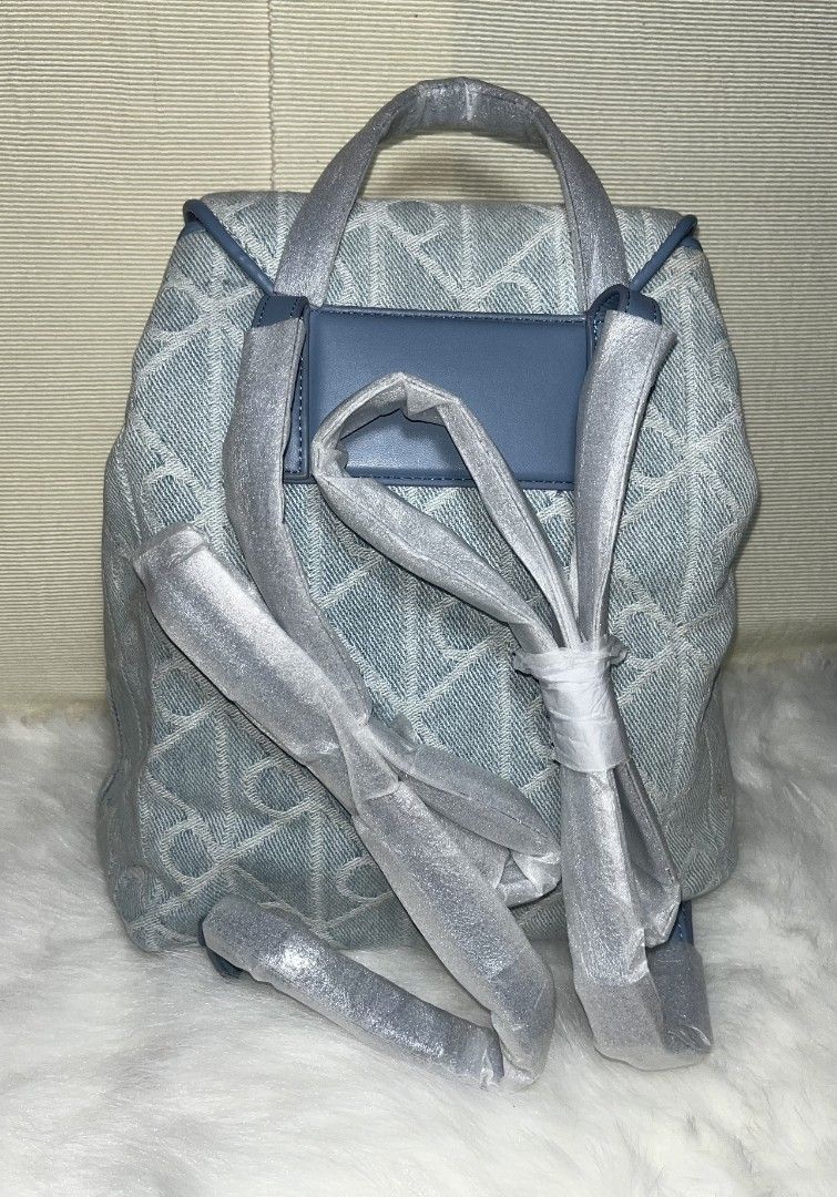 Calvin Klein Mono Denim Women's Backpack (Category: Backpacks) located in Imus. Submitted by maria_pilayo (Listing ID 1469970730, Image 2). Description: - Brand: Calvin Klein - 💯% Authentic - Style: Mono denim backpack with blue leather trim - Color: Light blue monogram - Closure: Drawstring - Dimensions: 11 inches (H) x 9.5 inches (W) - Condition: Brand new, straps and handle still in original protective packaging - 100% authentic and ready to 