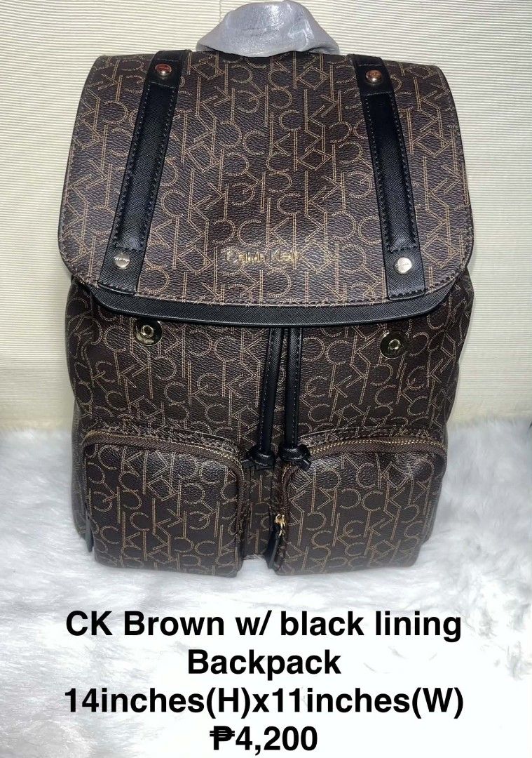 Calvin Klein Unisex Brown Monogram Backpack with Black Lining (Category: Backpacks) located in Imus. Submitted by maria_pilayo (Listing ID 1469971448, Image 1). Description: - Brand: Calvin Klein Unisex - 💯% Authentic - Color: Brown monogram with solid black accents - Size: Approx. 14" H x 11" W - Closure: Drawstring under front flap with polished gold hardware - Pockets: 2 front utility pockets with gold zippers - Straps: Adjustable back straps