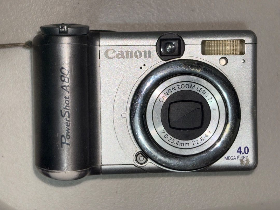 Canon PowerShot A80 Digital Camera (Category: Cameras) located in Caloocan City. Submitted by faith35 (Listing ID 1470045274, Image 1). Description: - Camera Model: Canon PowerShot A80 (Classic mid-2000s vintage digicam) - Resolution: 4.0 Megapixels with 3x optical zoom lens - Display: Unique rotating vari-angle LCD screen for easy low/high-angle shots - Modes: Full manual control plus easy auto settings via top mode dial - Power & Storage: Runs 