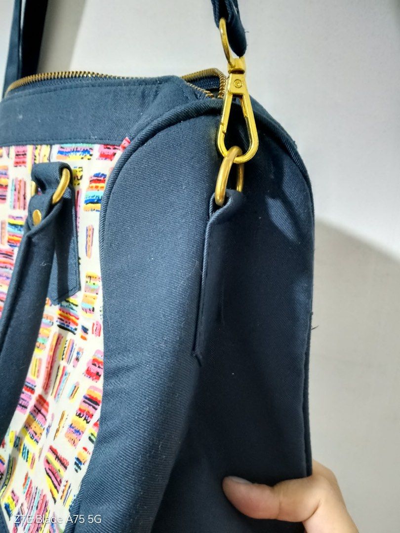 Canvas Handbag with Colorful Pattern and Shoulder Strap (Category: Shoulder Bags) located in Manila. Submitted by celesq_buys (Listing ID 1470013263, Image 2). Description: Navy blue canvas handbag with white front panel featuring colorful abstract patterns. Gold-tone hardware throughout. Double top handles plus an adjustable, detachable shoulder strap. Zip top closure. Clean fabric exterior and sturdy construction. Great everyday bag with plenty
