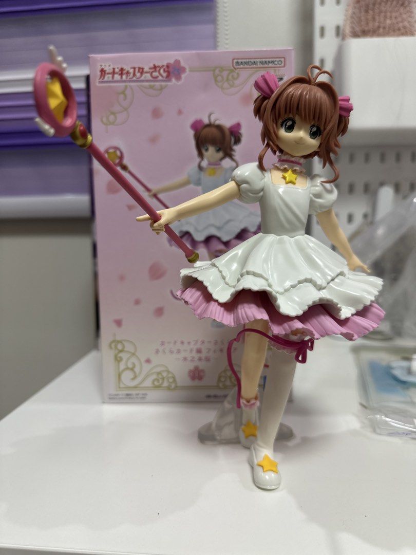 Cardcaptor Sakura Figure with Box (Category: Figurines & Statues) located in Manila. Submitted by silentfire.54ea36 (Listing ID 1470117725, Image 1). Description: - Authentic Bandai Namco release - Features Sakura in her detailed white and pink frilly dress holding her sealing wand - Includes clear display base for easy setup - Comes with original pink packaging box - Perfect addition for Cardcaptor Sakura fans and anime figure collectors.