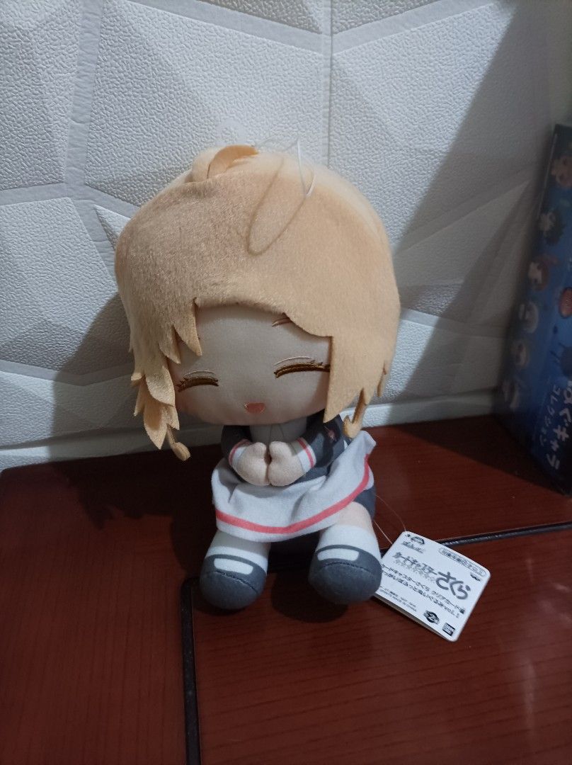 Cardcaptor Sakura Plush Doll Banpresto (Category: Plushies & Soft Toys) located in Bacoor. Submitted by kuroochiii94695 (Listing ID 1469994771, Image 1). Description: - Official Banpresto Cardcaptor Sakura merchandise - Cute sitting pose with hands clasped together - Wears her classic grey and white school uniform dress - Features short blonde hair and gentle closed eyes - Original tag still attached to the foot - Clean fabric with no stains, fla