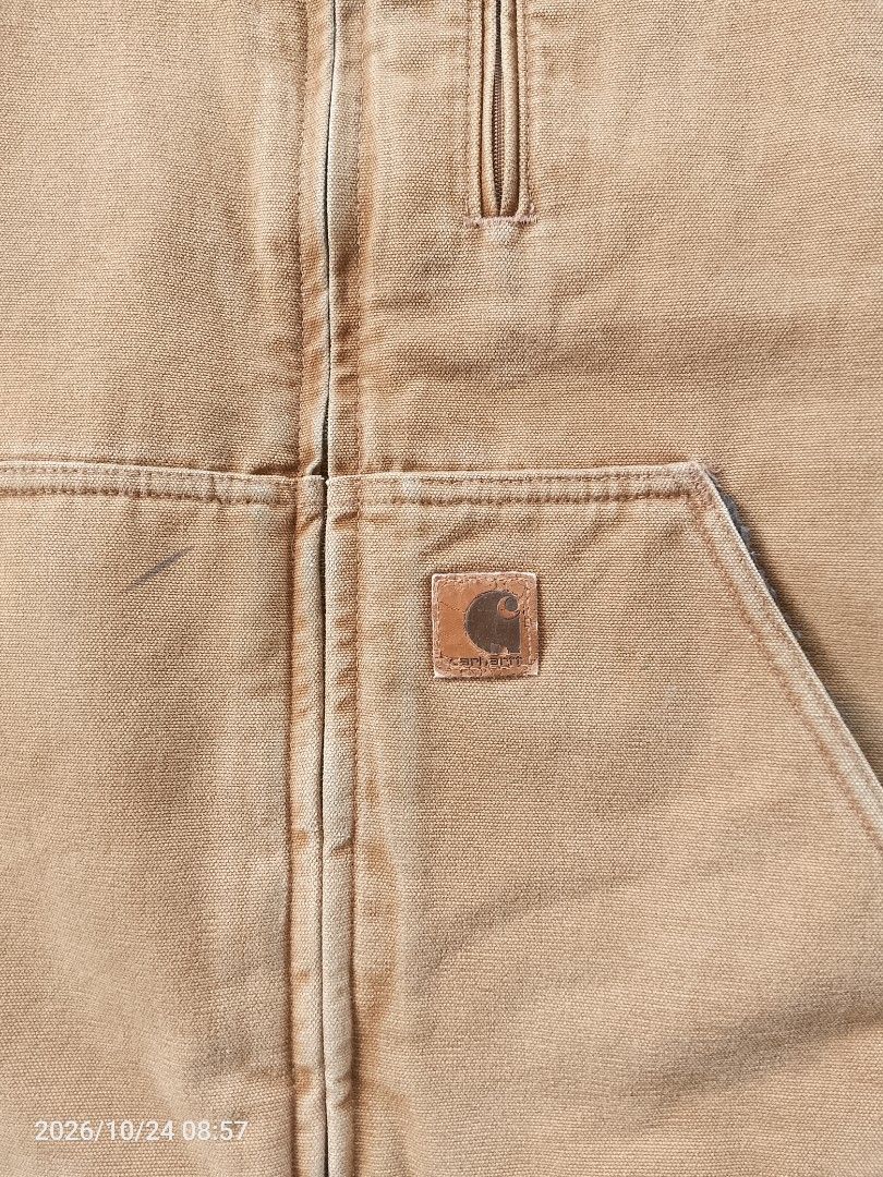 Carhartt Sherpa Lined Canvas Work Vest (Category: Vests) located in Bacolod City. Submitted by surfwear_in_negros (Listing ID 1469960463, Image 3). Description: - Brand/Style: Carhartt Duck Canvas Work Vest - Color: Classic Tan / Brown with Dark Grey Sherpa Fleece Lining - Features: Full zip front, stand-up collar, vertical chest zip pocket, and two large lower front pockets - Details: Iconic Carhartt square label on the lower pocket - Condition: