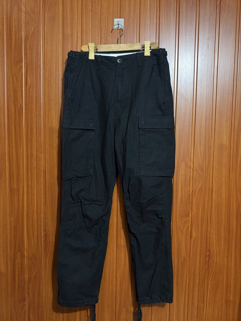 Carhartt WIP Black Cargo Pants (Category: Jeans) located in Manila. Submitted by tlfph (Listing ID 1470109488, Image 1). Description: - Brand: Carhartt WIP - Color: Black - Material: Tough, durable cotton built for daily wear - Pockets: Multiple utility pockets on sides and back - Fit: Adjustable waist tabs on both sides - Cuffs: Drawstring cuffs at the ankles - Branding: Classic woven Carhartt logo patch on the right cargo pocket.