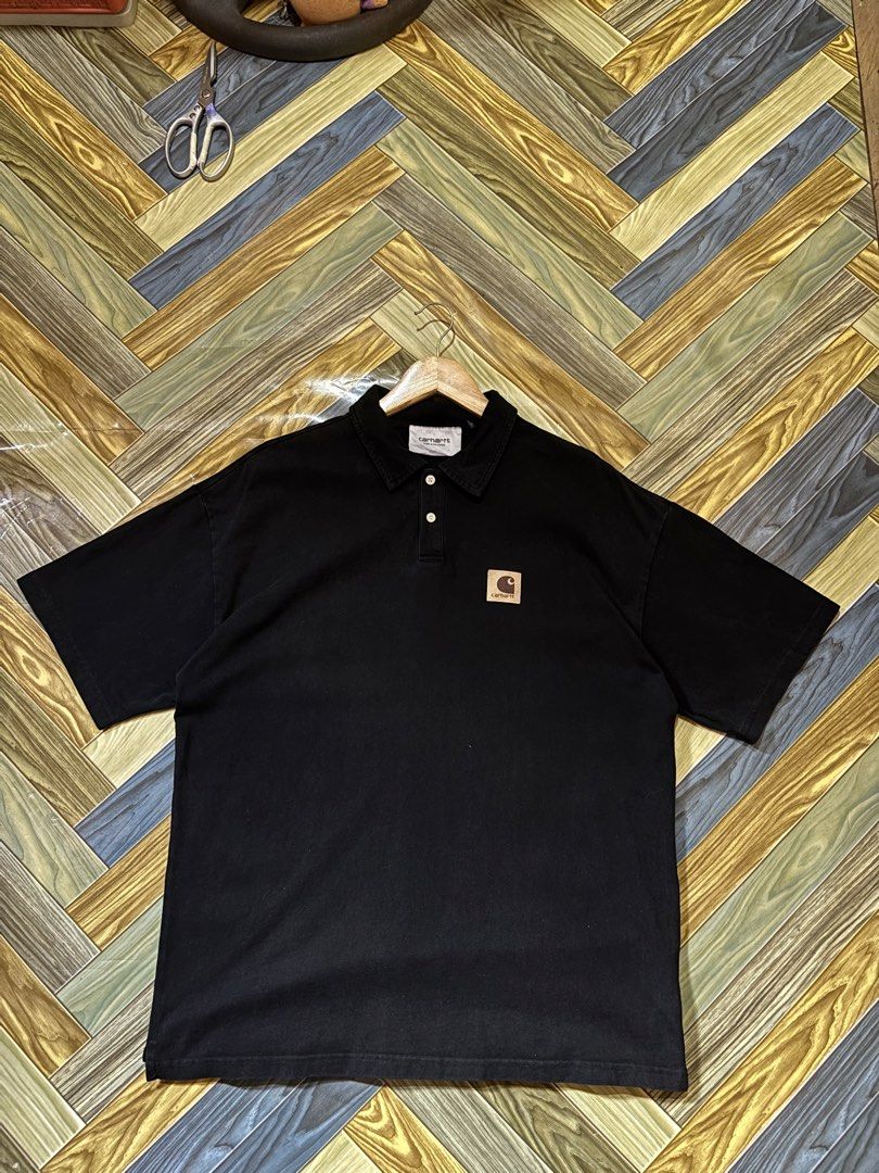 Carhartt WIP Black Polo Shirt with Square Patch (Category: Tshirts & Polo Shirts ) located in Manila. Submitted by thriftkibs (Listing ID 1470101579, Image 1). Description: - Brand: Carhartt WIP - Color: Black - Material: 100% cotton for maximum comfort - Fit: Relaxed fit with short sleeves - Design: Classic collar, two-button placket, and iconic square logo patch on the chest - Origin: Made in China.