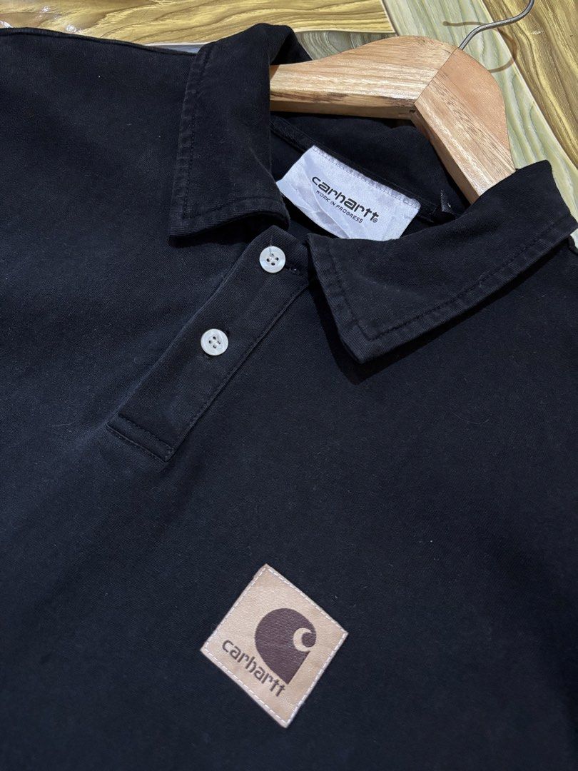 Carhartt WIP Black Polo Shirt with Square Patch (Category: Tshirts & Polo Shirts ) located in Manila. Submitted by thriftkibs (Listing ID 1470101579, Image 2). Description: - Brand: Carhartt WIP - Color: Black - Material: 100% cotton for maximum comfort - Fit: Relaxed fit with short sleeves - Design: Classic collar, two-button placket, and iconic square logo patch on the chest - Origin: Made in China.