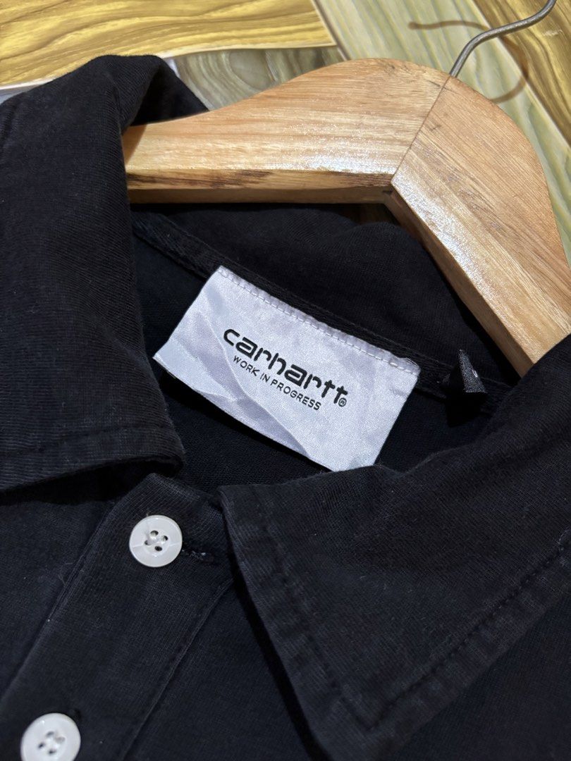 Carhartt WIP Black Polo Shirt with Square Patch (Category: Tshirts & Polo Shirts ) located in Manila. Submitted by thriftkibs (Listing ID 1470101579, Image 3). Description: - Brand: Carhartt WIP - Color: Black - Material: 100% cotton for maximum comfort - Fit: Relaxed fit with short sleeves - Design: Classic collar, two-button placket, and iconic square logo patch on the chest - Origin: Made in China.