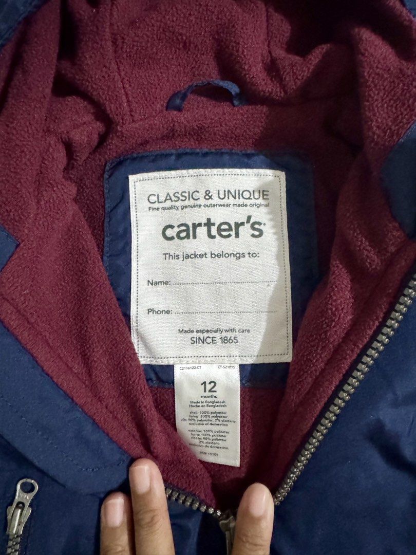 Baby Jacket (Category: Babies & Kids Fashion) located in Paranaque City. Submitted by april_anythingpreloved (Listing ID 1470084577, Image 2). Description: - Brand: Carter's - Size on tag: 12 Months - Color: Deep navy blue exterior with cozy maroon fleece lining and hood - Closure: Front zipper - Features: Interior tag for name and phone number - Condition: Great piece for cold weather - Bought in the US -RFS: Decluttering.