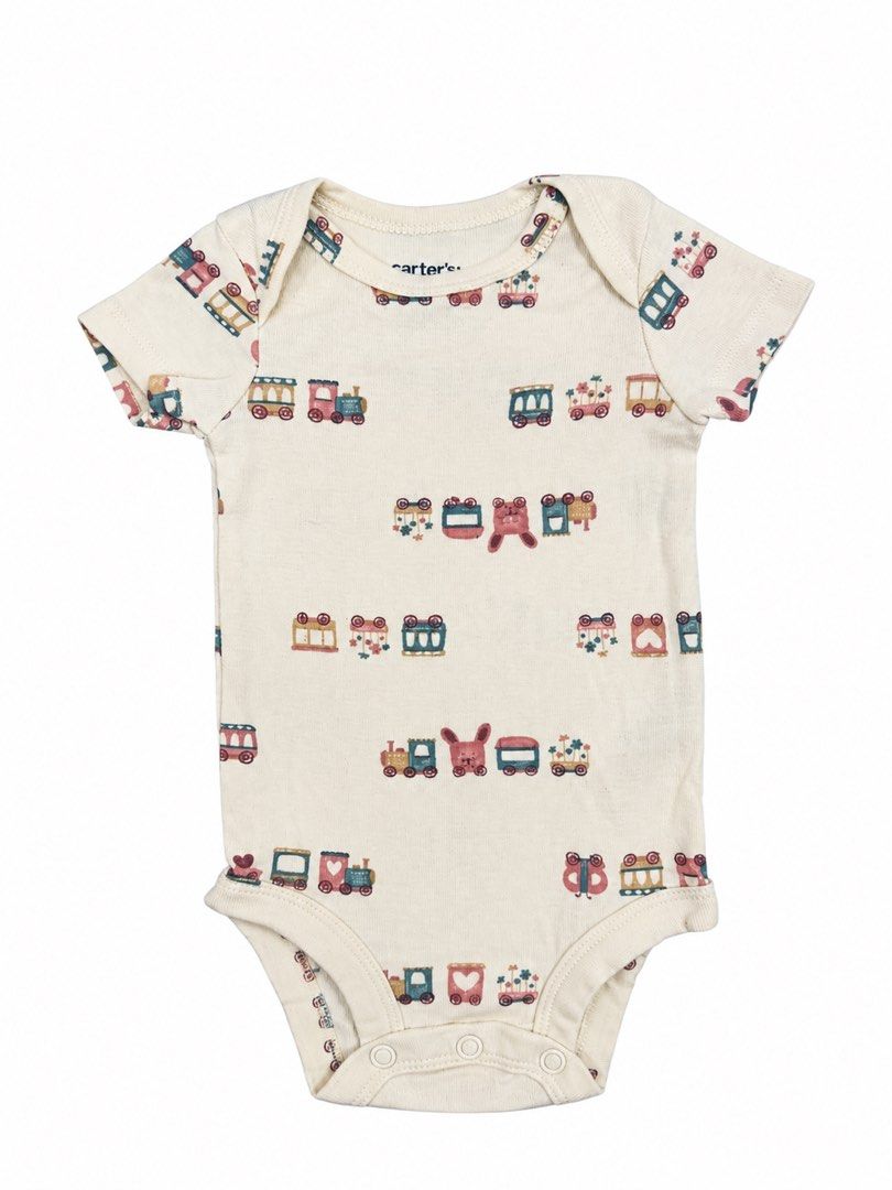 Carter’s Onesie (3M) (Category: Babies & Kids Fashion) located in Angeles City. Submitted by aeapreloved (Listing ID 1470057466, Image 1). Description: Carter’s Baby Onesie 🚂 Cream-colored short-sleeve onesie with cute vintage train prints. Soft and comfy for everyday wear. • Brand: Carter’s • Size: 3 months • Snap-button closure at the bottom • Cute and colorful train design .
