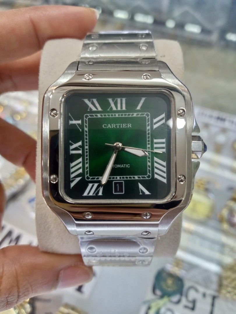 Cartier Santos Automatic Watch (Category: Luxury Watches) located in Las Pinas. Submitted by teampeewee888 (Listing ID 1470015895, Image 3). Description: - Model: Cartier Santos Automatic - Case & Bracelet: Stainless steel with protective plastic wraps still on links - Dial Features: Classic Roman numeral markers, date window near the bottom edge, and multiple color variants available - Movement: Automatic - Special Detail: Crown fitted with a si