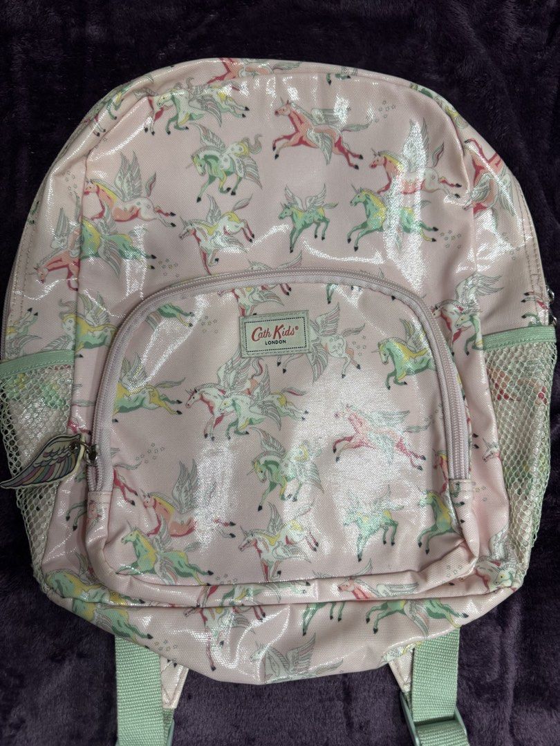 Cath Kids London Unicorn Pink Backpack (Category: Backpacks) located in Valenzuela. Submitted by sofiasticated.decluttering (Listing ID 1470069681, Image 1). Description: - Brand: Cath Kidston Kids - Design: Pink with all-over winged unicorn print - Storage: Main compartment, front zip pocket with cute wing pull, and dual mesh side pockets - Comfort: Adjustable shoulder straps and top hanging loop - Interior: Pink lining with a convenient slip po