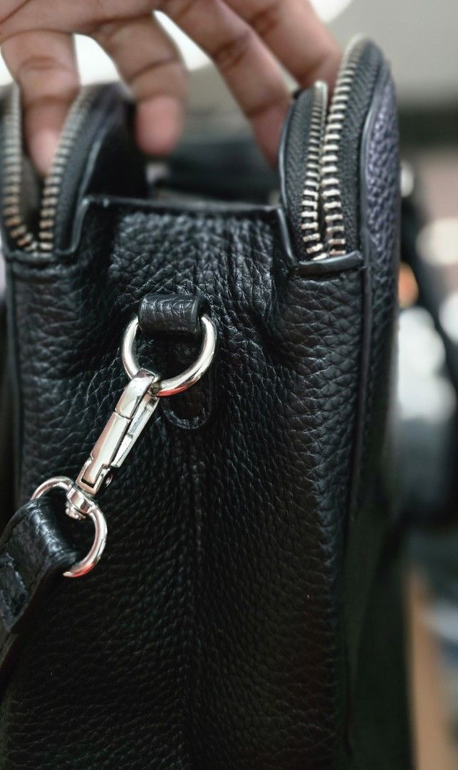 Catwalk Black Textured Handbag with Shoulder Strap (Category: Shoulder Bags) located in Manila. Submitted by ubasirene (Listing ID 1470083487, Image 2). Description: - Brand: Catwalk fromm sweden - Material: Black faux leather with textured pebble finish - Hardware: Sleek silver-tone zippers and rings - Carry Options: Dual top handles + adjustable, detachable shoulder strap - Closure: Secure top zip closure - Interior: Clean lining with multiple 
