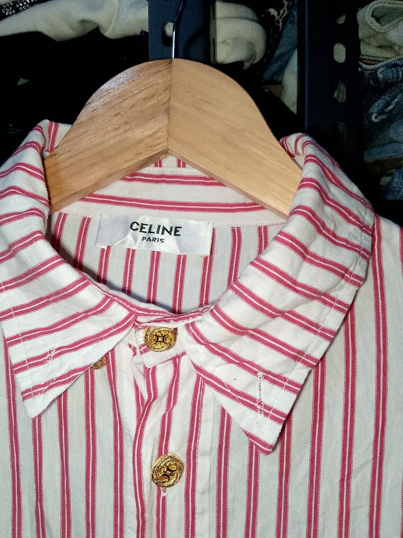 Celine Red White Striped Button Up Shirt (Category: Shirts) located in Manila. Submitted by mjthrifted_second (Listing ID 1469970257, Image 2). Description: - Brand: Celine Paris -Dimes: 22/27 - Design: Red and white stripes with classic collar - Details: Long sleeves with embroidered Celine lettering on cuffs, chest pocket with red embroidered Celine logo - Hardware: Gold-toned front buttons - Condition: Excellent pre-loved condition - Perfect f