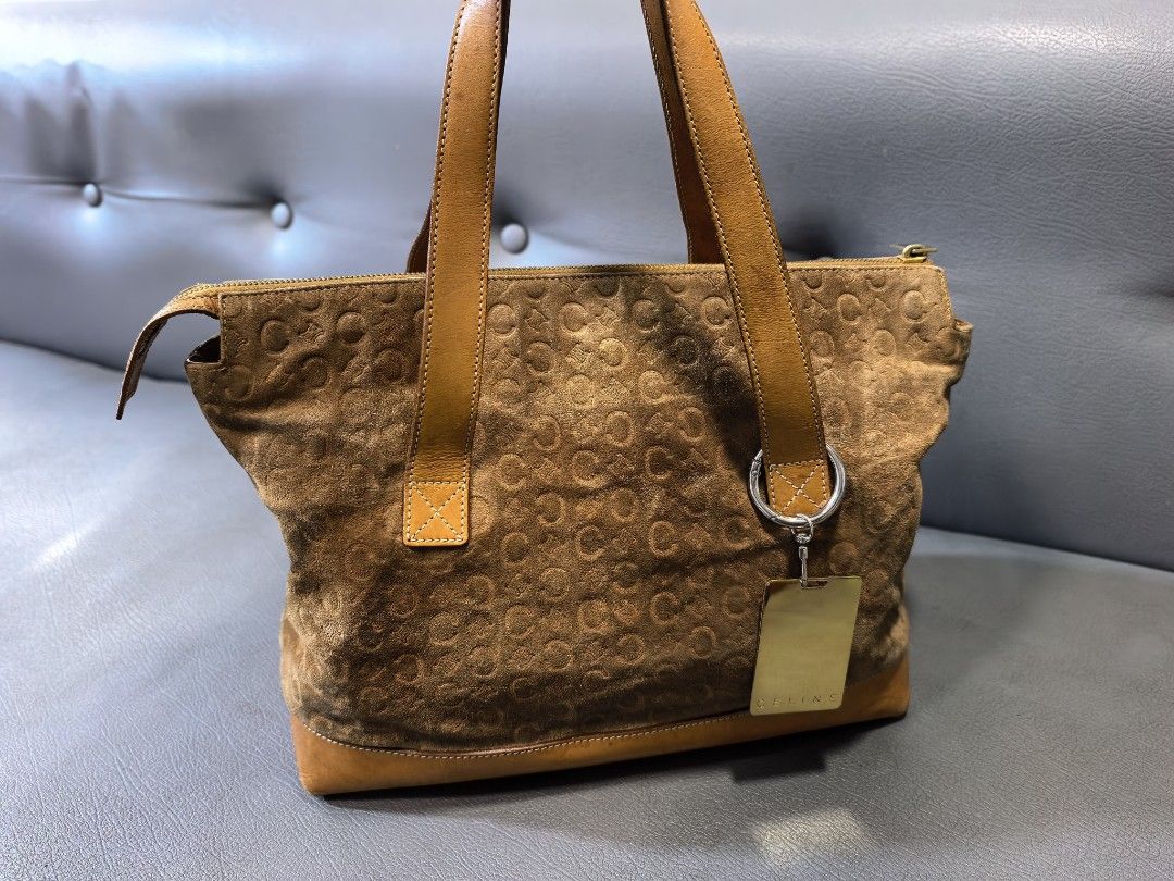 Celine Suede C Initial Pattern Tote Bag Brown Tan (Category: Luxury Bags & Wallets) located in Cagayan de Oro. Submitted by pootx (Listing ID 1470091816, Image 1). Description: -please check the last photo sa issues - Authentic Celine tote bag made in Italy (Serial No: MC00/1) - Brown suede body with signature C monogram pattern and tan leather trim - Dual top handles and protective metal feet on the bottom - Secure top zip closure with branded g