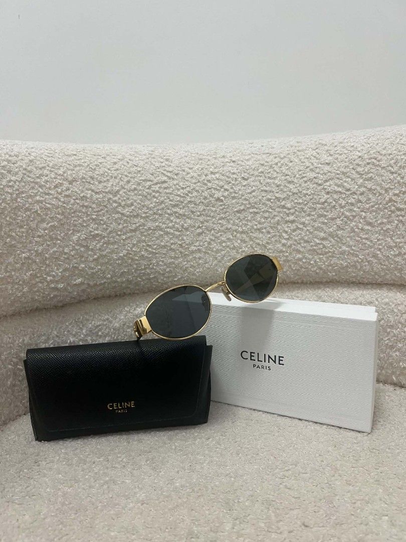 Celine Triomphe Gold Oval Sunglasses (Category: Sunglasses & Eyewear) located in Paoay. Submitted by rvf1230 (Listing ID 1469980089, Image 2). Description: - Brand: Celine - Style: Gold metal oval frames with dark lenses - Details: Iconic gold Triomphe logo hardware on temples with black tips - Condition: Beautiful luxury designer eyewear - Inclusions: Original black leather hard case, white branded box.