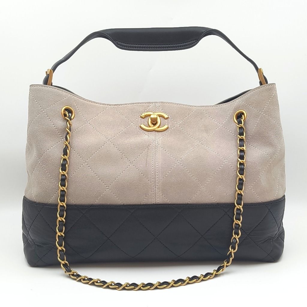 Chanel 25A Coco Shopping Bag Small Grey Black (Category: Luxury Bags & Wallets) located in Cebu City. Submitted by affordabagss (Listing ID 1470003666, Image 1). Description: Chanel 25A Coco Shopping Bag crafted in grey quilted suede with contrasting black quilted lambskin leather along the base. Accented with gold-tone CC hardware, leather-interwoven chain detailing, and an adjustable black leather shoulder handle. The spacious open-top silhouet