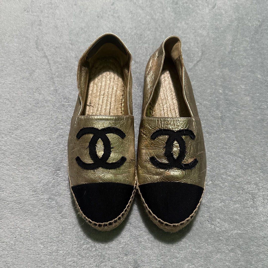 Chanel CC Logo Metallic Gold Black Cap Toe Espadrilles (Category: Sneakers & Footwear) located in Bayombong. Submitted by rochelle_archive_garments (Listing ID 1470039765, Image 3). Description: - Brand: Chanel - Style: Metallic gold leather espadrilles with slip-on flat design - Details: Black cap toe with embroidered black CC logo - Midsole: Classic braided jute - Authenticity: Stamped serial number inside - Condition: Shows surface wear and cr