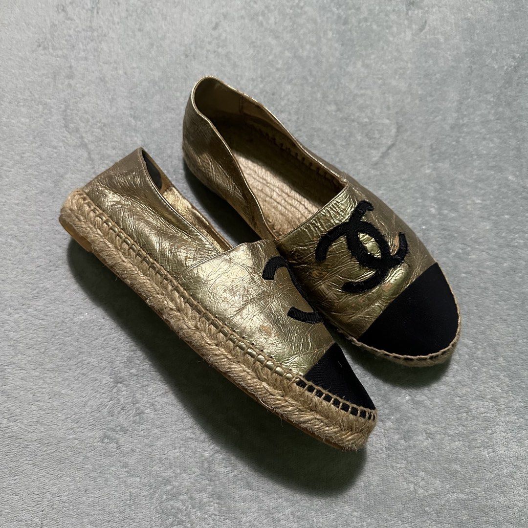 Chanel CC Logo Metallic Gold Black Cap Toe Espadrilles (Category: Sneakers & Footwear) located in Bayombong. Submitted by rochelle_archive_garments (Listing ID 1470039765, Image 2). Description: - Brand: Chanel - Style: Metallic gold leather espadrilles with slip-on flat design - Details: Black cap toe with embroidered black CC logo - Midsole: Classic braided jute - Authenticity: Stamped serial number inside - Condition: Shows surface wear and cr