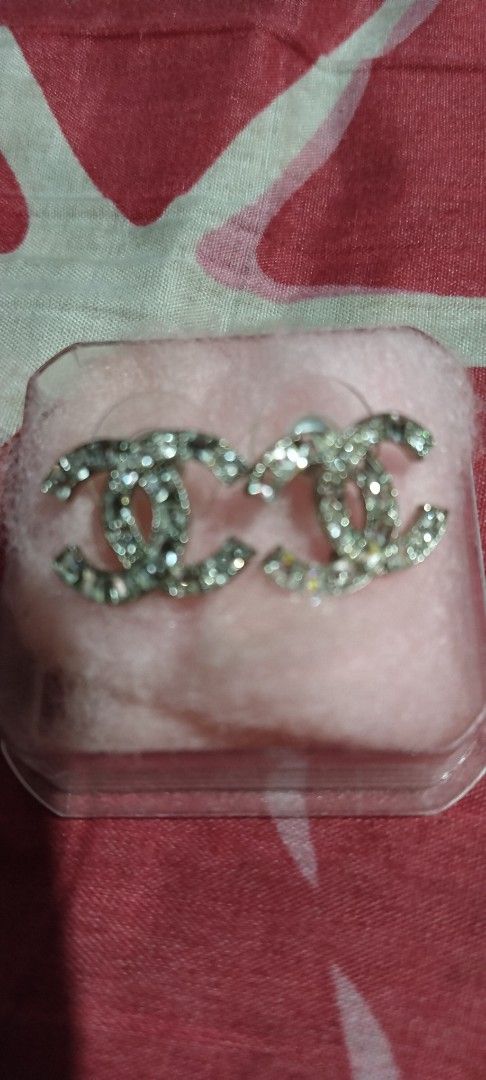 Chanel CC Rhinestone Silver Stud Earrings (Category: Earrings) located in Manila. Submitted by hellow2024 (Listing ID 1470055147, Image 1). Description: - Brand: Chanel - Style: Silver CC logo crystal stud earrings - Details: Sparkly rhinestones, hallmarked and stamped 'Made in France' on back -large in size - Closure: Push-back with secure plastic backs - Inclusion: no box - Condition: Great statement piece for day or evening wear.