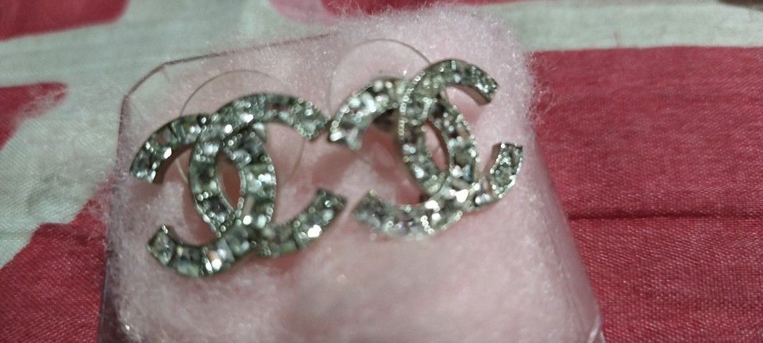 Chanel CC Rhinestone Silver Stud Earrings (Category: Earrings) located in Manila. Submitted by hellow2024 (Listing ID 1470055147, Image 2). Description: - Brand: Chanel - Style: Silver CC logo crystal stud earrings - Details: Sparkly rhinestones, hallmarked and stamped 'Made in France' on back -large in size - Closure: Push-back with secure plastic backs - Inclusion: no box - Condition: Great statement piece for day or evening wear.