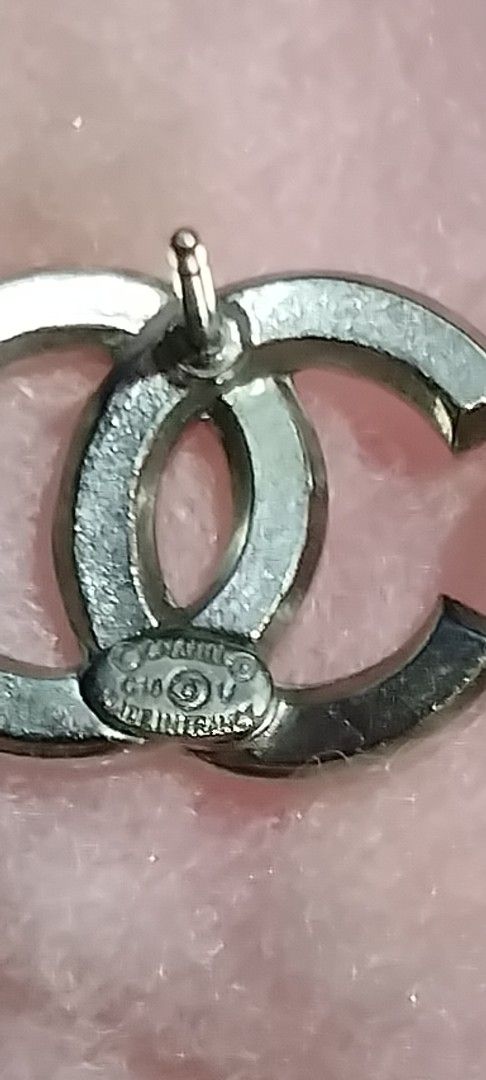 Chanel CC Rhinestone Silver Stud Earrings (Category: Earrings) located in Manila. Submitted by hellow2024 (Listing ID 1470055147, Image 3). Description: - Brand: Chanel - Style: Silver CC logo crystal stud earrings - Details: Sparkly rhinestones, hallmarked and stamped 'Made in France' on back -large in size - Closure: Push-back with secure plastic backs - Inclusion: no box - Condition: Great statement piece for day or evening wear.