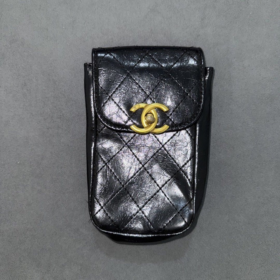 Chanel Phone/Make Up Holder Pouch (Category: Luxury Bags & Wallets) located in Calasiao. Submitted by jafaith_man (Listing ID 1470077789, Image 1). Description: Chanel-branded quilted black faux-leather smartphone/phone holder pouch featuring a gold-tone CC turn-lock closure.