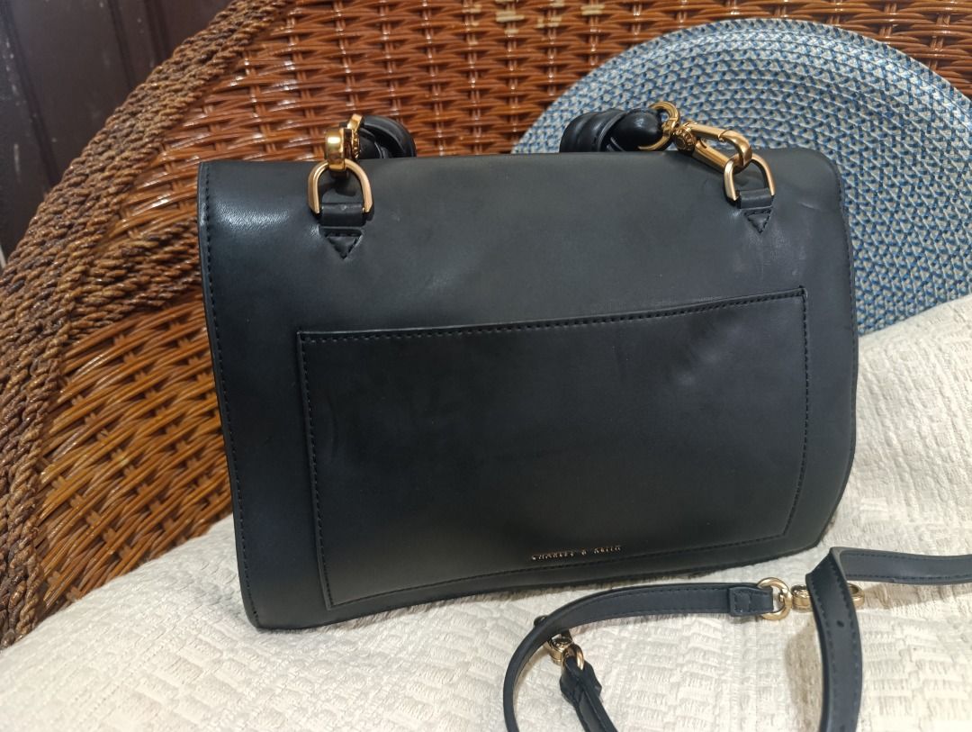 Charles & Keith Black Top Handle Crossbody Bag (Category: Cross-body Bags) located in Malolos. Submitted by vintagefat (Listing ID 1469964025, Image 3). Description: - Brand: Charles & Keith - Color: Classic Black with elegant Gold hardware - Versatile design: Includes a top handle and a detachable strap - Stylish details: Textured vertical stitching panel under the front flap - Secure & Accessible: Magnetic button closure and an exterior back po