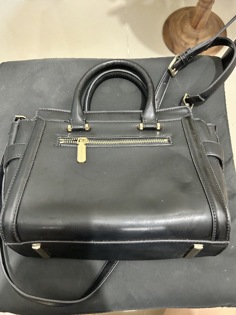 Charles & Keith Black Tote Bag with Strap (Category: Tote Bags) located in Quezon City. Submitted by saltynsweetluvr (Listing ID 1470038402, Image 2). Description: - Brand: Charles & Keith - Color: Classic Black with chic gold-tone hardware - Design: Structured tote bag with textured side panels and buckle accents - Versatility: Includes dual top handles and an adjustable/removable shoulder strap - Storage: Secure top zipper closure, exterior bac