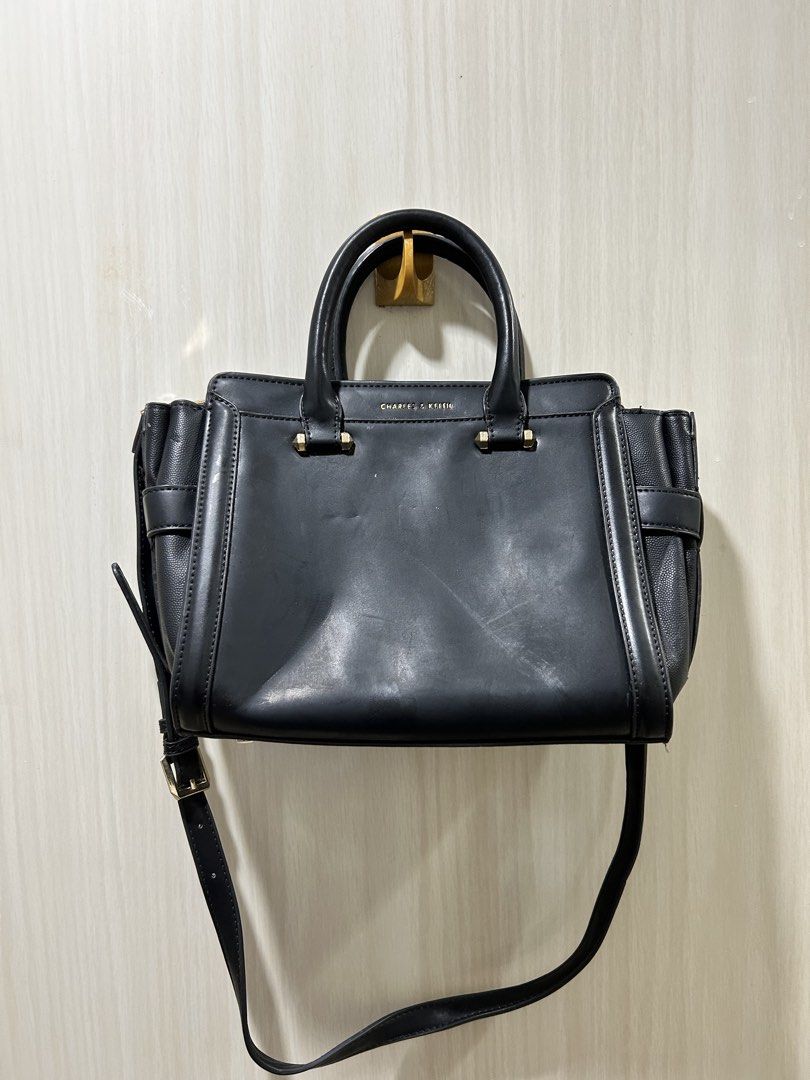 Charles & Keith Black Tote Bag with Strap (Category: Tote Bags) located in Quezon City. Submitted by saltynsweetluvr (Listing ID 1470038402, Image 3). Description: - Brand: Charles & Keith - Color: Classic Black with chic gold-tone hardware - Design: Structured tote bag with textured side panels and buckle accents - Versatility: Includes dual top handles and an adjustable/removable shoulder strap - Storage: Secure top zipper closure, exterior bac